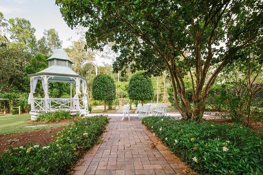 Brick path through the gardens to the rotunda, chairs set for a ceremony
