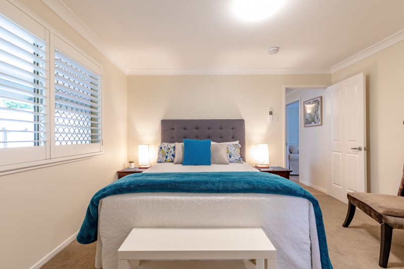 The second Queen Suite with plantation shutters and a garden outlook