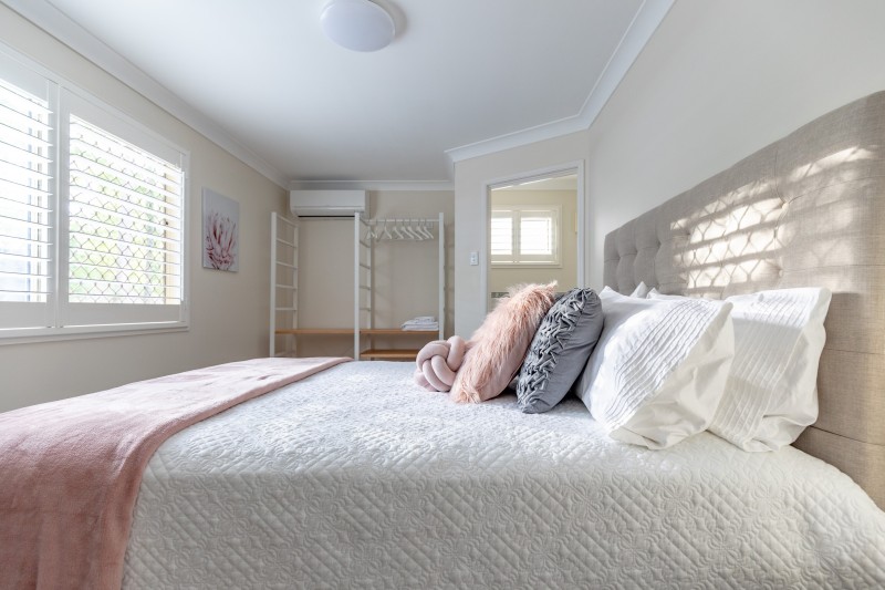 A Queen Suite bedroom in soft blush and white tones