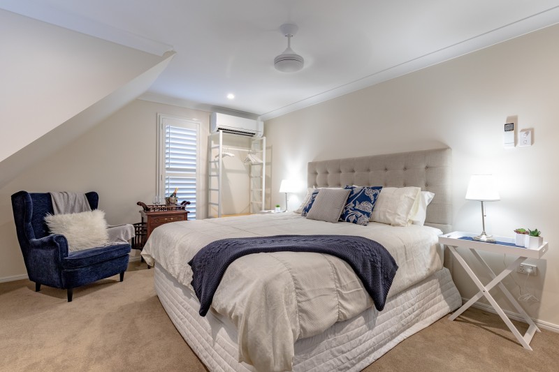 The King Suite bedroom with a king bed, reading chair and sloped ceiling